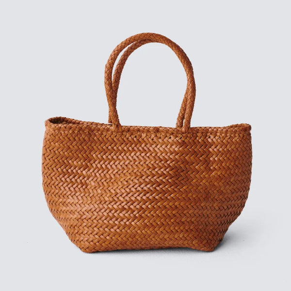 Brown woven handbag on a light gray background