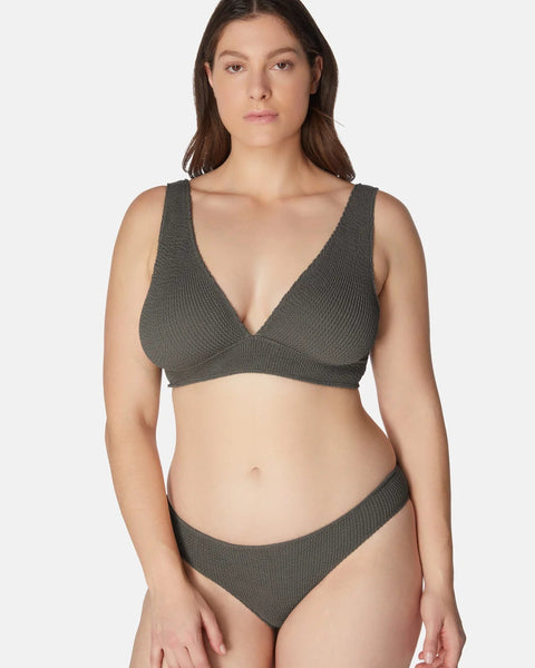 Woman wearing a gray bikini set on a white background