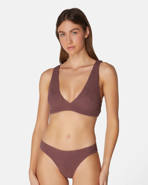 Woman wearing a brown bikini set on a white background
