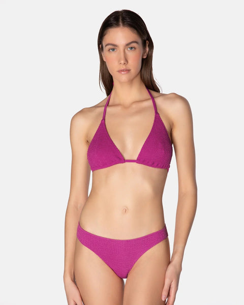 Woman wearing a purple bikini on a white background