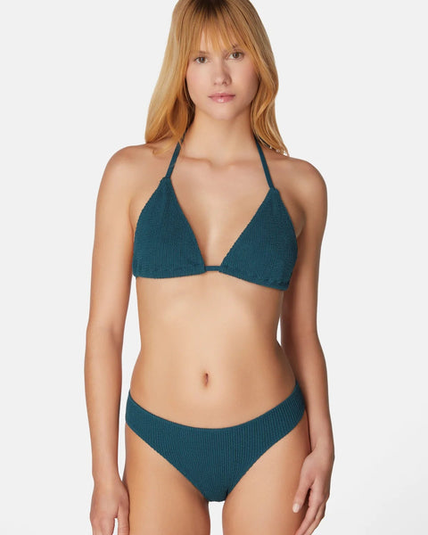 Woman wearing a teal bikini on a white background