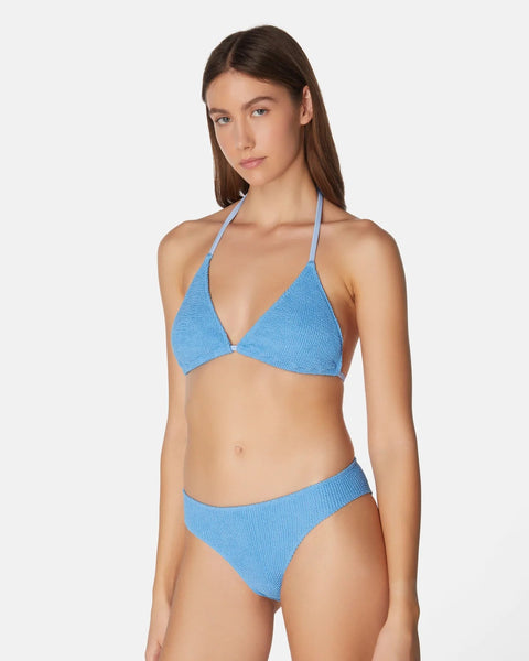 Woman wearing a blue bikini on a white background