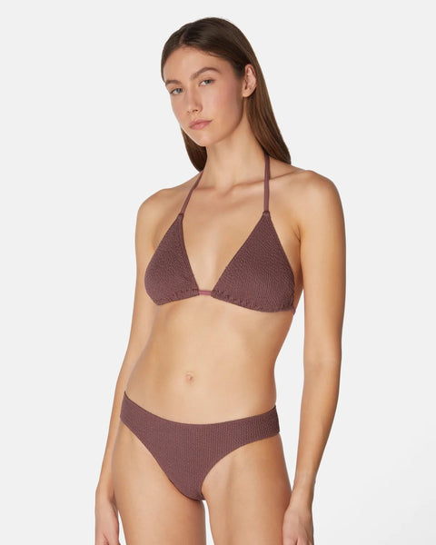 Woman wearing a brown bikini set on a white background