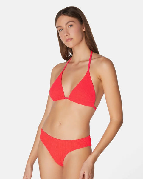 Woman wearing a red bikini on a white background