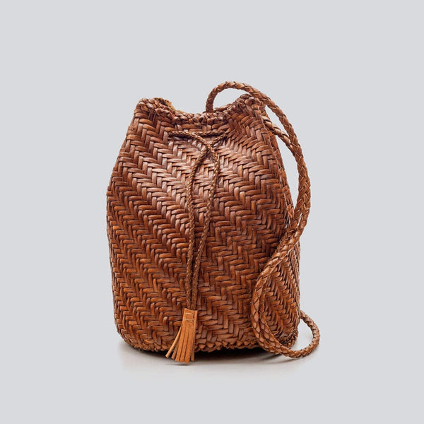 Woven brown bucket bag on a light gray background