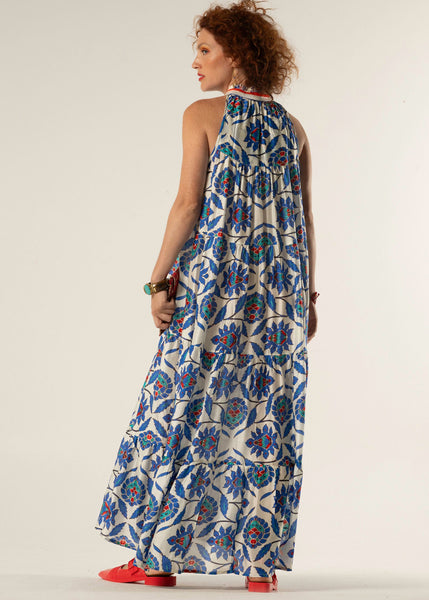 Woman wearing a sleeveless floral dress with a white background