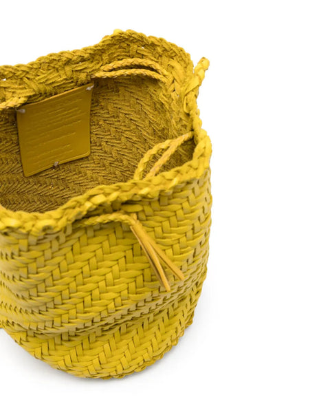 Yellow woven basket on a white background