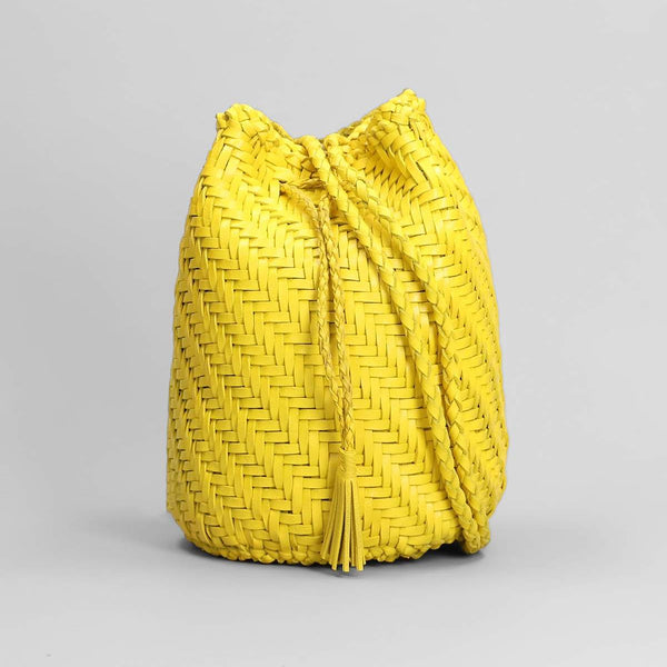Yellow woven bucket bag on a light gray background